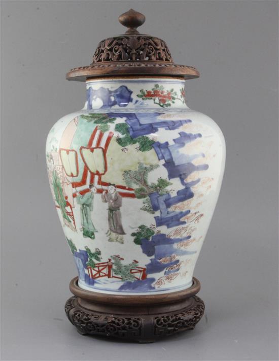 A Chinese wucai baluster jar, Transitional period, 17th century, height 28cm excl. carved hongmu stand and cover